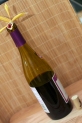 half empty wine bottle with orchid and bamboo